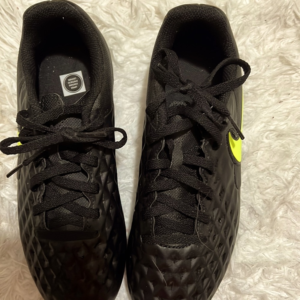 Black and neon green cleats